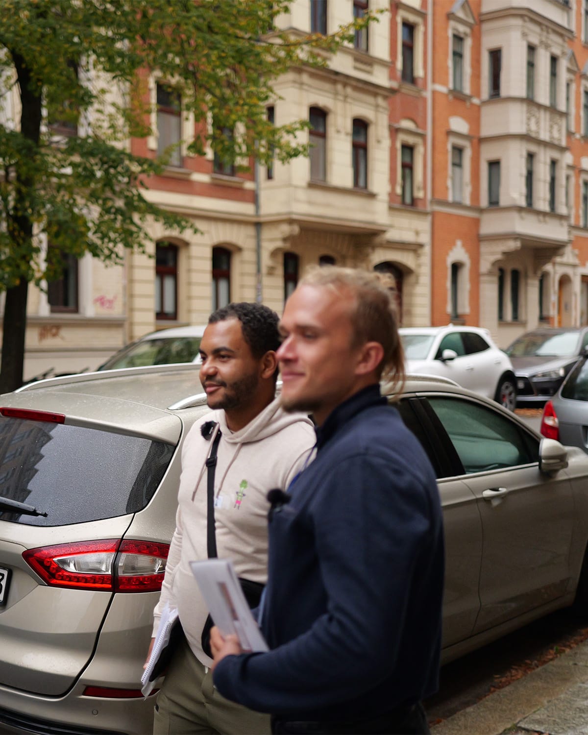 Two members of the association walking along a residential street